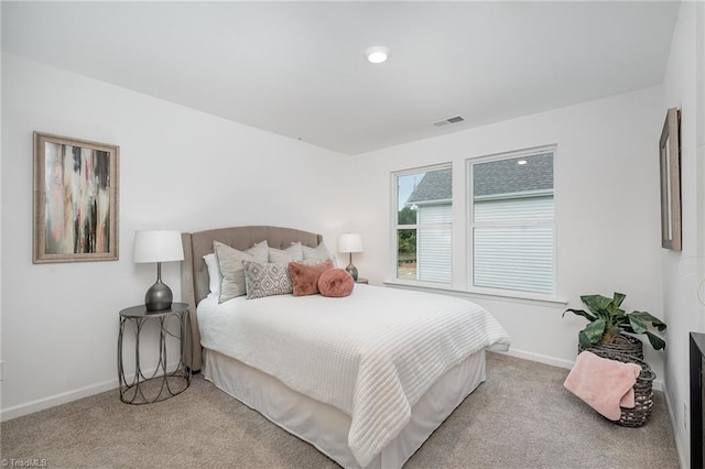 bedroom featuring light colored carpet