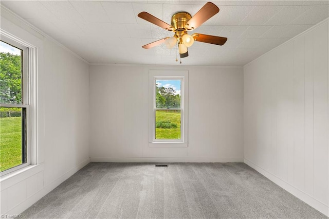 empty room with visible vents, light carpet, ceiling fan, and plenty of natural light