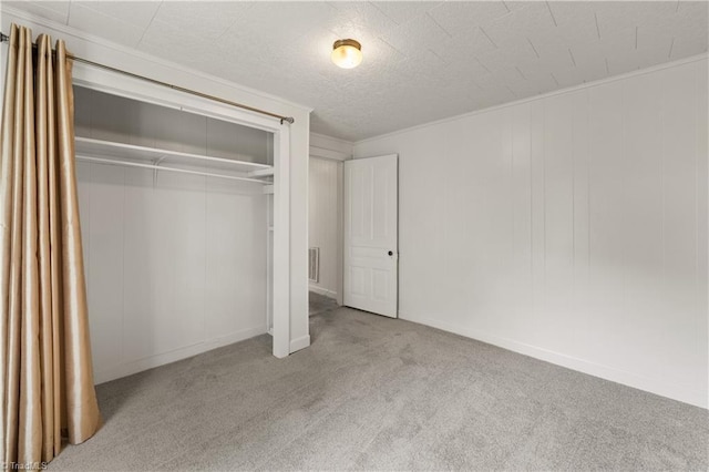 unfurnished bedroom with a closet, carpet flooring, baseboards, and visible vents