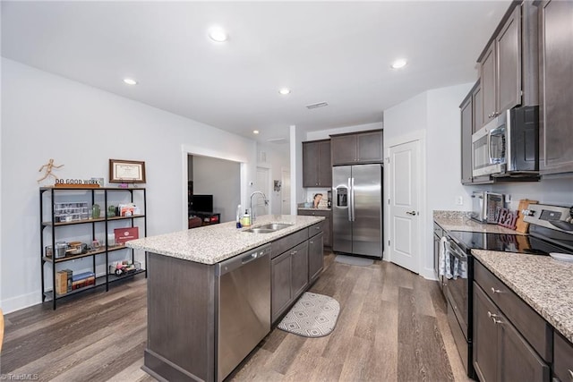 3903 Sudley Pt Unit 18, Jamestown, NC 27282 - kitchen featuring appliances with stainless steel finishes, dark wood-style floors, an island with sink, light stone countertops, and recessed lighting