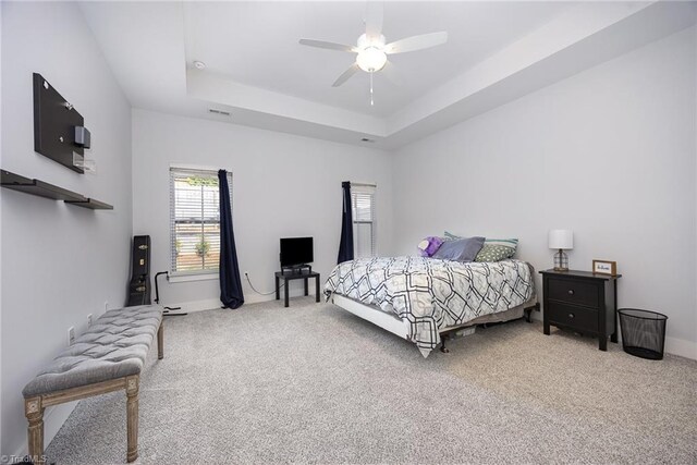 3903 Sudley Pt Unit 18, Jamestown, NC 27282 - carpeted bedroom featuring a tray ceiling and ceiling fan