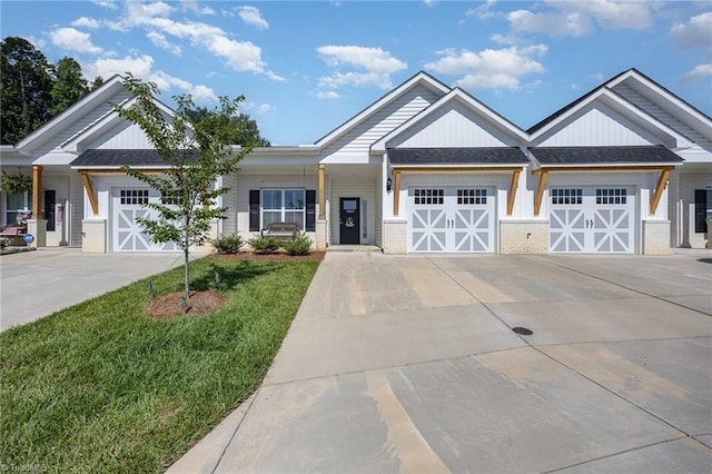 3903 Sudley Pt Unit 18, Jamestown, NC 27282 - view of front of home featuring concrete driveway, a garage, brick siding, a front yard, and roof with shingles