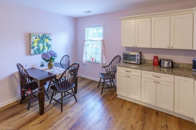 dining space with light hardwood / wood-style flooring