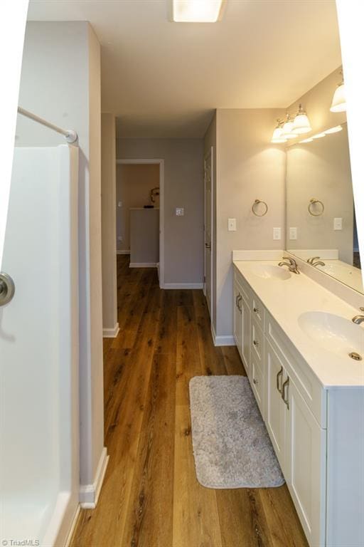 bathroom with vanity and hardwood / wood-style floors