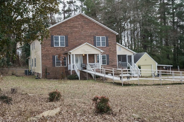 view of front of home featuring central AC unit, a garage, an outdoor structure, and a porch