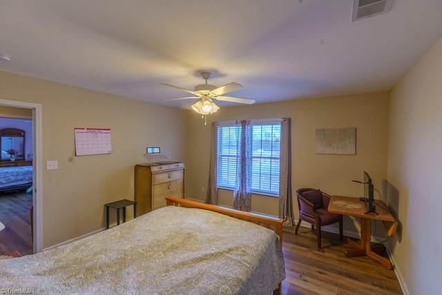 bedroom featuring dark hardwood / wood-style flooring and ceiling fan