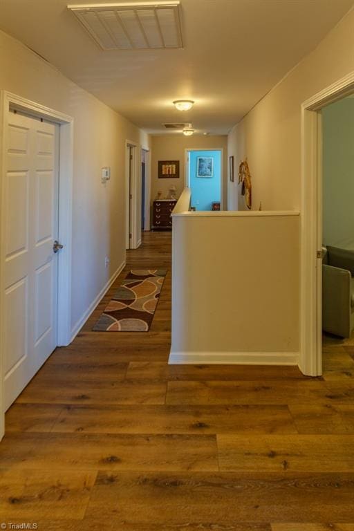 hall with hardwood / wood-style flooring