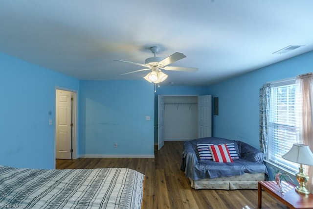 bedroom with ceiling fan, dark hardwood / wood-style flooring, and a closet