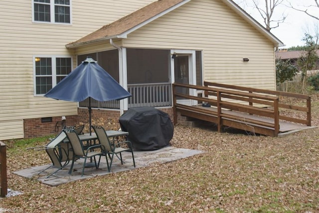 rear view of property featuring a patio and a deck