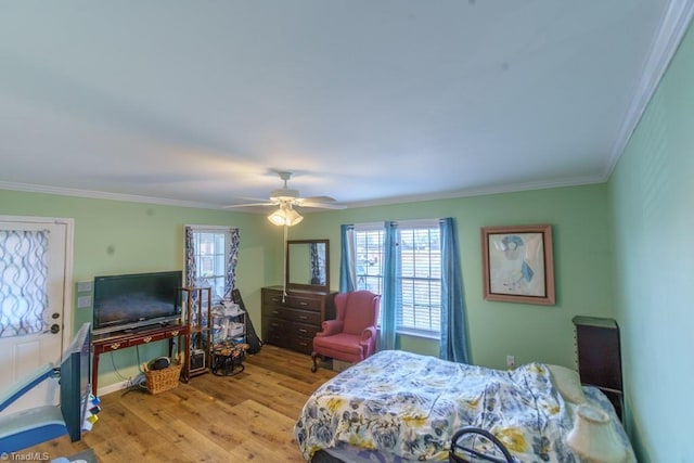 bedroom featuring ornamental molding, ceiling fan, and light hardwood / wood-style floors