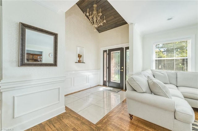 tiled foyer entrance with an inviting chandelier