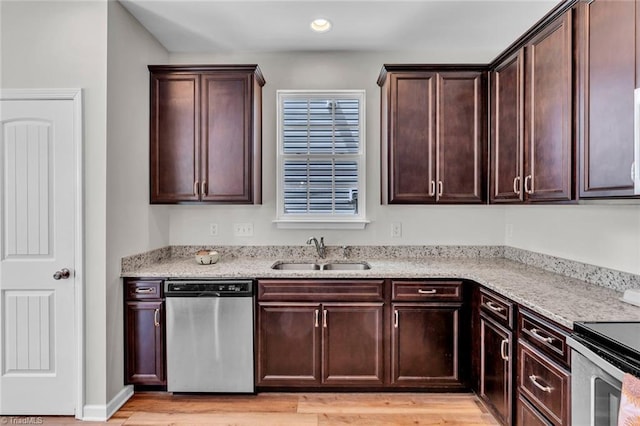 kitchen with light stone countertops, dishwasher, dark brown cabinets, a sink, and light wood-style floors