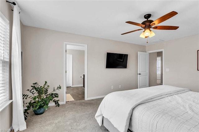 carpeted bedroom with baseboards and ceiling fan
