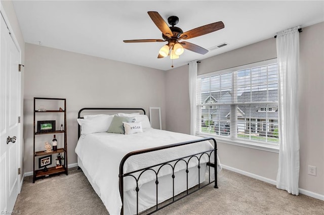 carpeted bedroom with baseboards, multiple windows, and visible vents