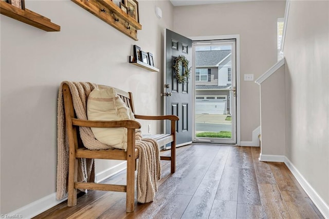 living area featuring baseboards and wood finished floors