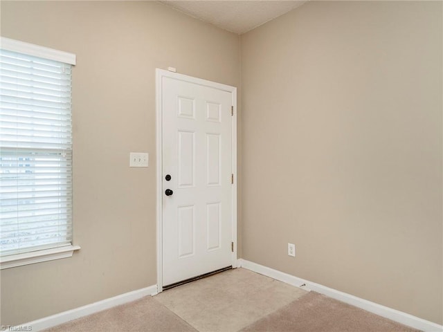 spare room featuring light carpet