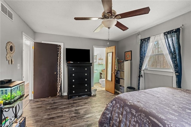 bedroom featuring visible vents, connected bathroom, wood finished floors, a textured ceiling, and a ceiling fan