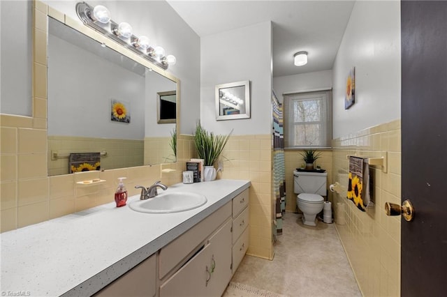 full bathroom with toilet, tile walls, wainscoting, and vanity