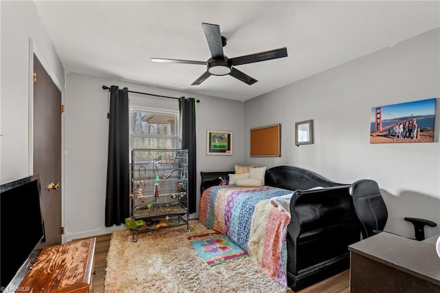 bedroom with a ceiling fan and wood finished floors