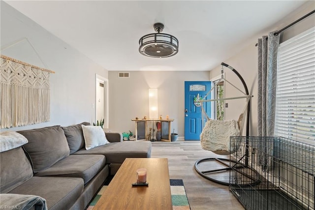 living room with visible vents and wood finished floors