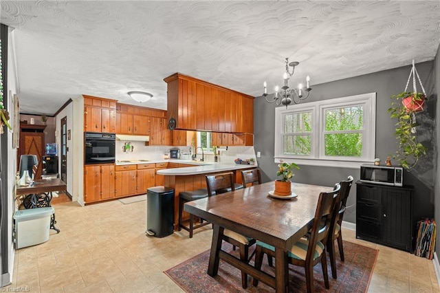 dining space featuring a chandelier and a textured ceiling