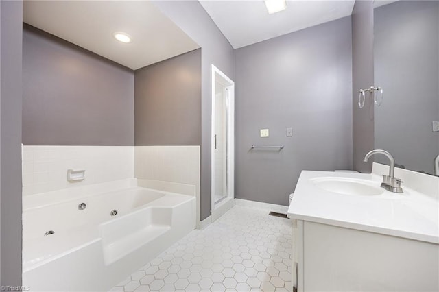4904 Landaff Dr, Greensboro, NC 27406 - bathroom with vanity, a jetted tub, tile patterned floors, baseboards, and a stall shower