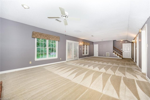 4904 Landaff Dr, Greensboro, NC 27406 - unfurnished living room with light carpet, baseboards, stairway, a ceiling fan, and vaulted ceiling