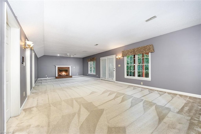 4904 Landaff Dr, Greensboro, NC 27406 - unfurnished living room featuring light carpet, baseboards, vaulted ceiling, and a fireplace