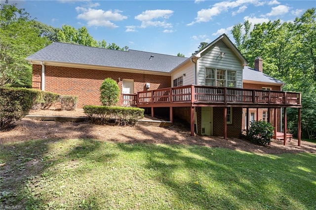 4904 Landaff Dr, Greensboro, NC 27406 - rear view of property featuring a wooden deck, brick siding, a lawn, and a chimney