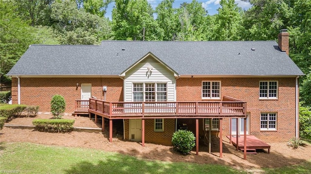 4904 Landaff Dr, Greensboro, NC 27406 - back of property with a deck, a chimney, brick siding, and a shingled roof