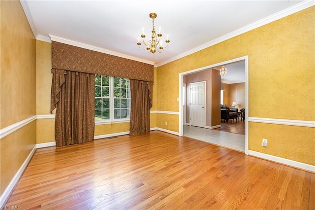 4904 Landaff Dr, Greensboro, NC 27406 - unfurnished room with a chandelier, wood finished floors, baseboards, and crown molding