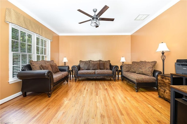 4904 Landaff Dr, Greensboro, NC 27406 - living room featuring light wood-style floors, ceiling fan, ornamental molding, and baseboards