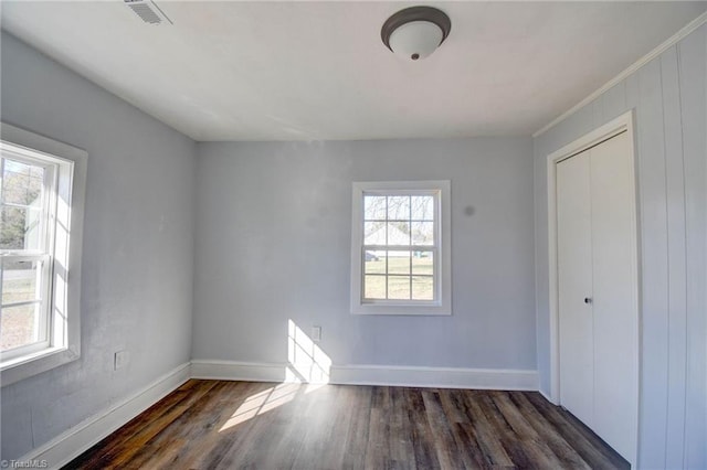 interior space featuring dark hardwood / wood-style floors, a closet, and ornamental molding