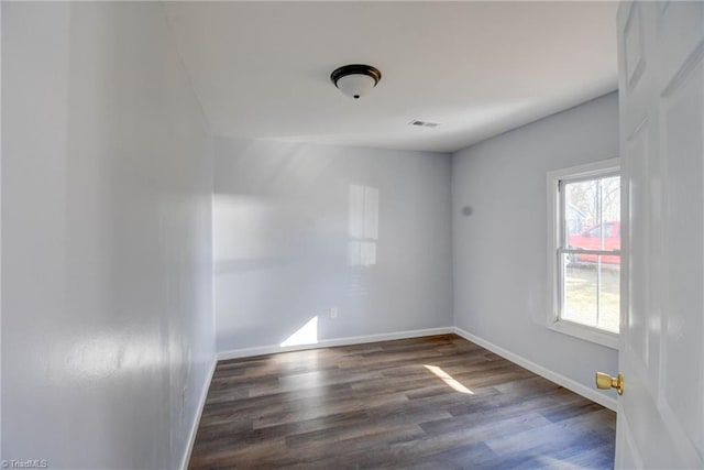 spare room featuring dark wood-type flooring