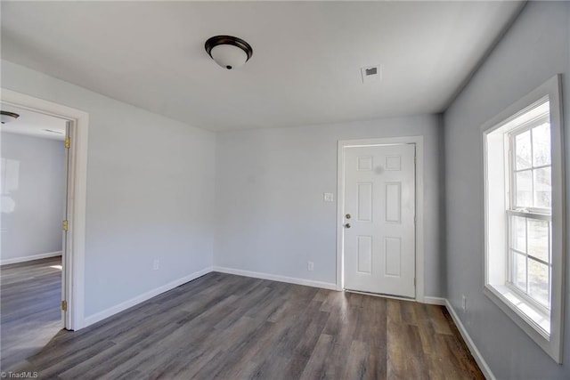 spare room with dark hardwood / wood-style flooring