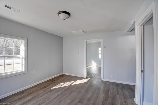 empty room with dark hardwood / wood-style floors