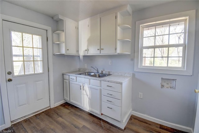 kitchen with white cabinetry, sink, and dark hardwood / wood-style floors