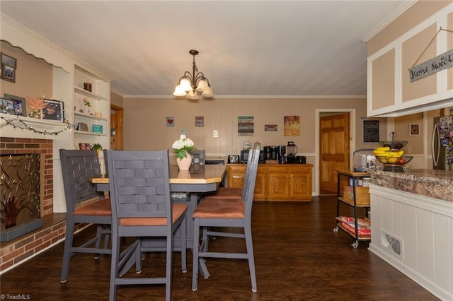 dining area featuring crown molding, dark wood-style floors, and a chandelier