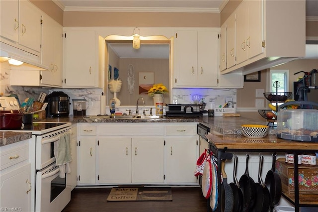 kitchen with decorative backsplash, white cabinetry, dark countertops, and double oven range