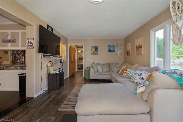 living room with dark wood-type flooring and ornamental molding