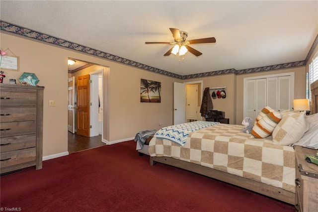 bedroom featuring baseboards, a ceiling fan, a closet, and dark carpet