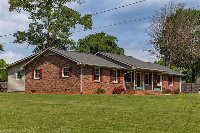exterior space featuring a porch, brick siding, a lawn, and crawl space