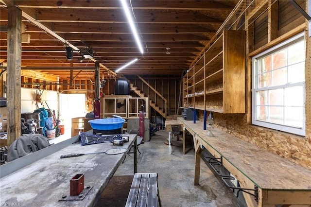 miscellaneous room with a workshop area and concrete floors