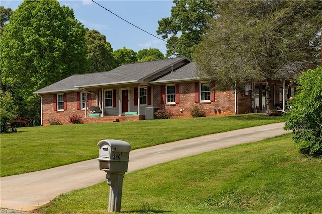 single story home with covered porch, a front yard, and brick siding