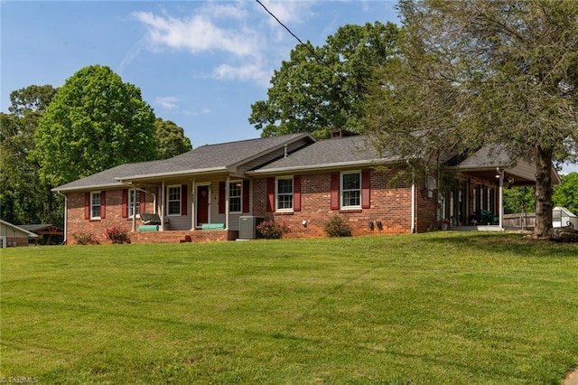 view of front facade with covered porch, brick siding, cooling unit, and a front yard