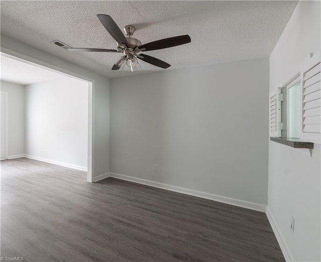 909 Shelby Dr Unit B, Greensboro, NC 27409 - spare room featuring a ceiling fan, dark wood-style flooring, baseboards, a textured ceiling, and healthy amount of natural light