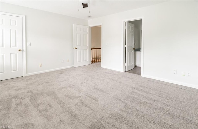 909 Shelby Dr Unit B, Greensboro, NC 27409 - unfurnished bedroom with carpet floors, baseboards, and ensuite bathroom