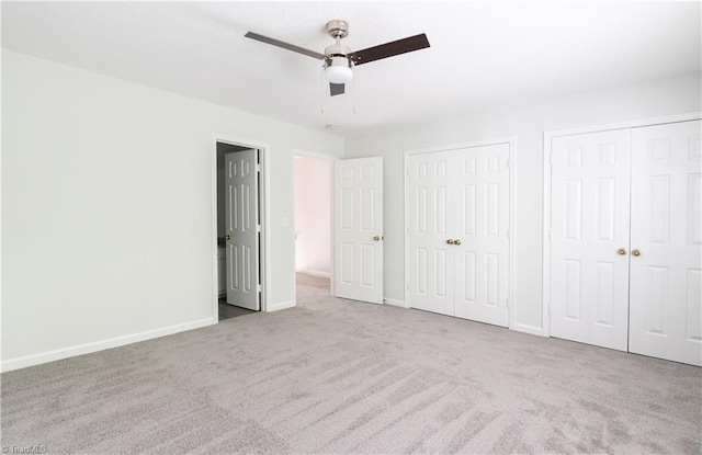 909 Shelby Dr Unit B, Greensboro, NC 27409 - unfurnished bedroom with multiple closets, carpet, baseboards, and a ceiling fan