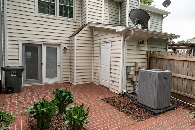 909 Shelby Dr Unit B, Greensboro, NC 27409 - view of exterior entry with central AC, fence, and a patio area