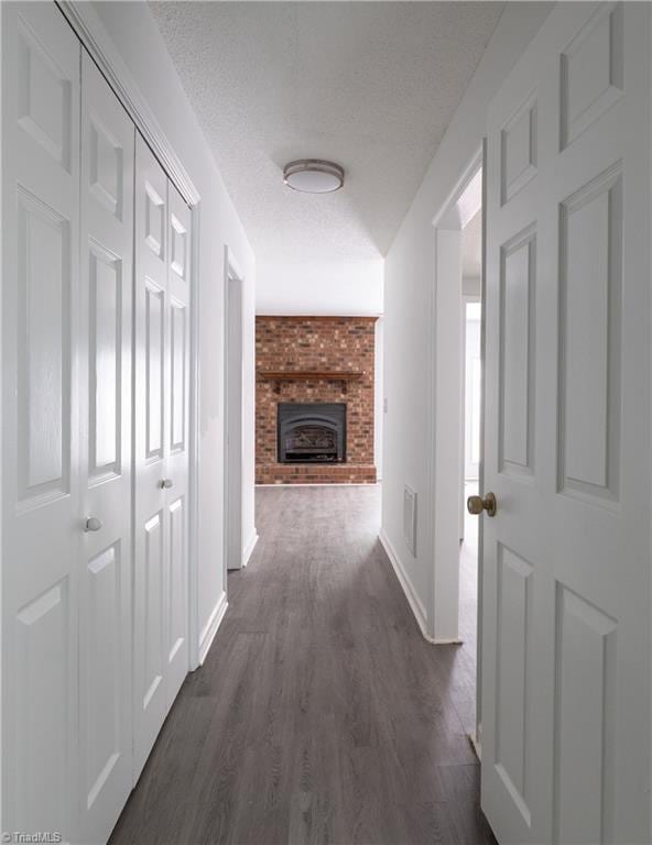 909 Shelby Dr Unit B, Greensboro, NC 27409 - corridor featuring baseboards, dark wood-type flooring, and a textured ceiling